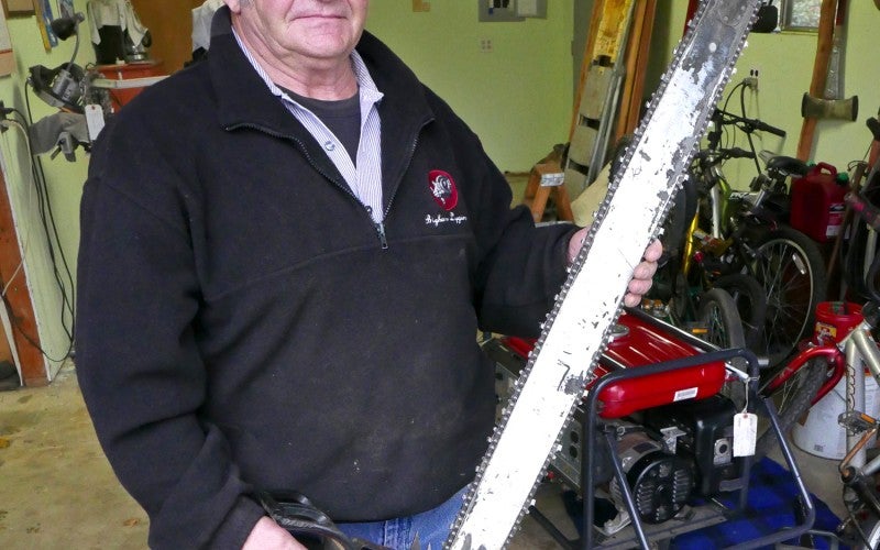 Luis Vidart holds a chainsaw