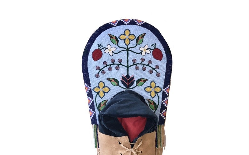 Nimiipuu Pleateau Cradeboard, a traditional style cradleboard in teh Nimiipuu (Nez Perce) style. This cradleboard was made with wood, buckskin, velvet and is fully beaded.