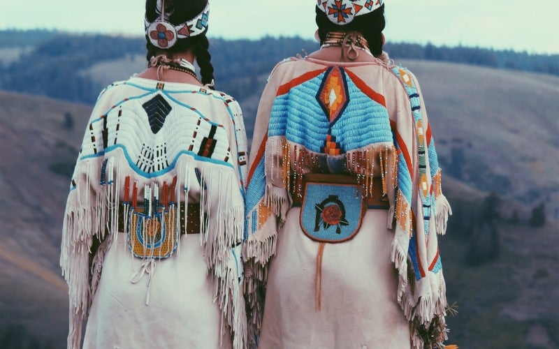 Two Plateau Buckskin Dresses, containing a beaded "deer tail" triangle (signifying the tail of a deer). 