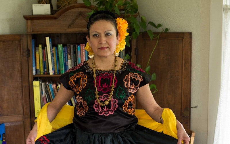 Maria Laguna poses while wearing black ballet folklorico dress.