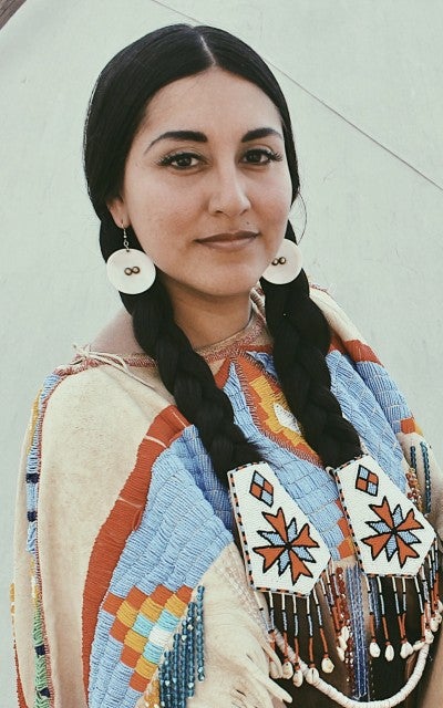 Portrait of Katie Harris Murphy, Native American woman wearing beaded buckskin.